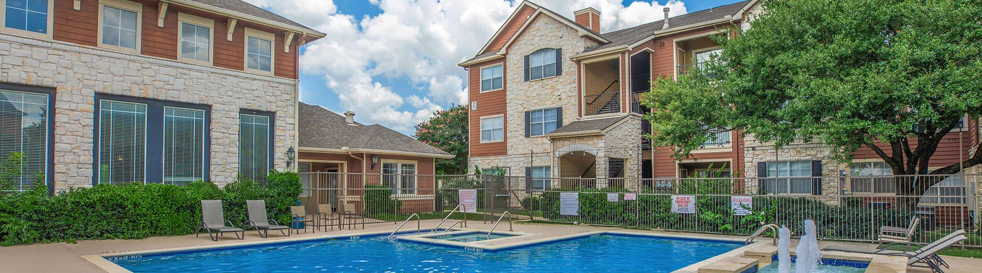 outdoor swimming pool area of an apartment community